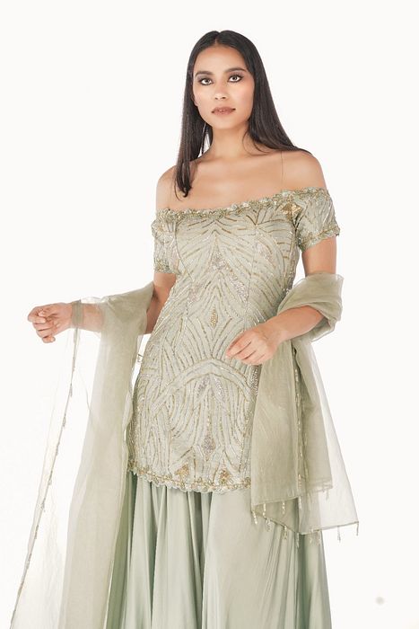 A model showcasing Sea Weed Off Soulder Sharara Set by Shruti S Label from Shruti S Label's collection A model showcasing Sea Weed Off Soulder Sharara Set by Shruti S Label from Shruti S Label's collection