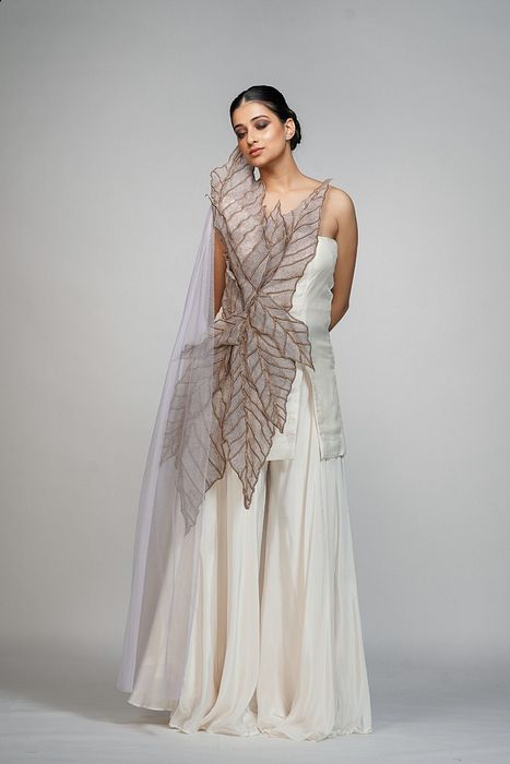 A model showcasing Off White Leaf Sharara Suit by Shruti S Label from Shruti S Label's collection