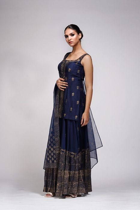 A model showcasing Metallic Print Navy Blue Sharara Suit by Shruti S Label from Shruti S Label's collection