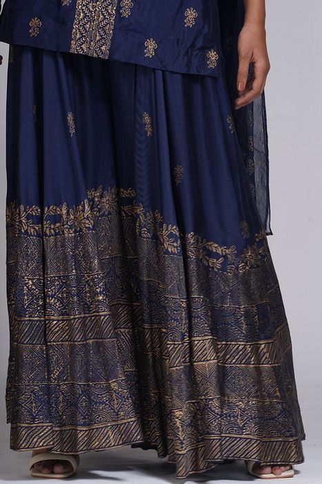 A model showcasing Metallic Print Navy Blue Sharara Suit by Shruti S Label from Shruti S Label's collection