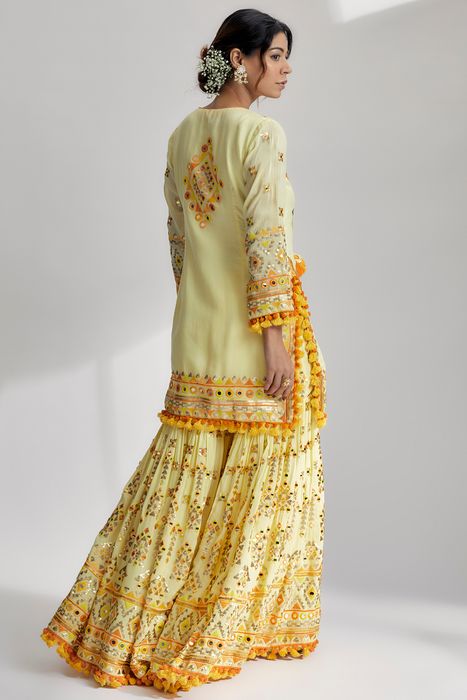A model showcasing Yellow Friya Short Kurta Sharara Set by Gopi Vaid from Gopi Vaid's collection