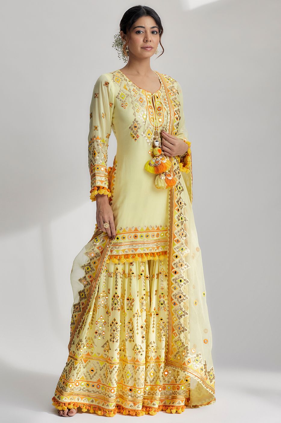 A model showcasing Yellow Friya Short Kurta Sharara Set Feature image by Gopi Vaid from Gopi Vaid's collection