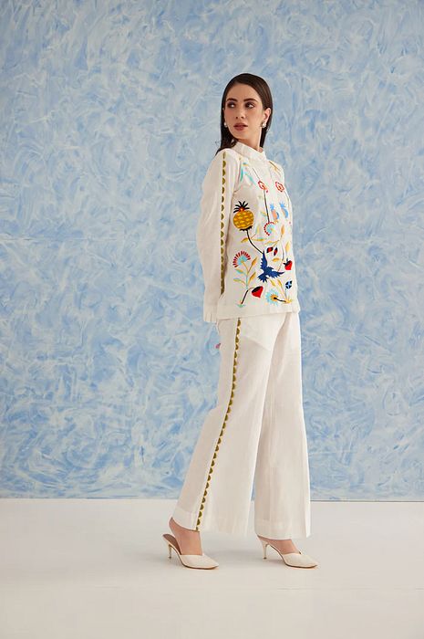 A model showcasing White Linen Pine Set by Fuga Clothing from Fuga Clothing's collection A model showcasing White Linen Pine Set by Fuga Clothing from Fuga Clothing's collection