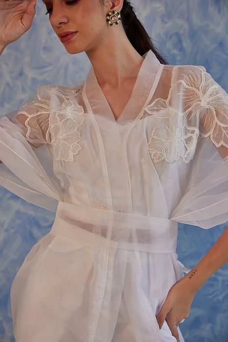 A model showcasing White Sheer Set by Fuga Clothing from Fuga Clothing's collection A model showcasing White Sheer Set by Fuga Clothing from Fuga Clothing's collection