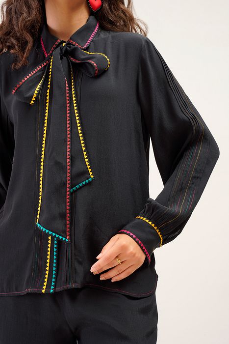 A model showcasing Elodie Shirt by Stitch Stories from Stitch Stories's collection