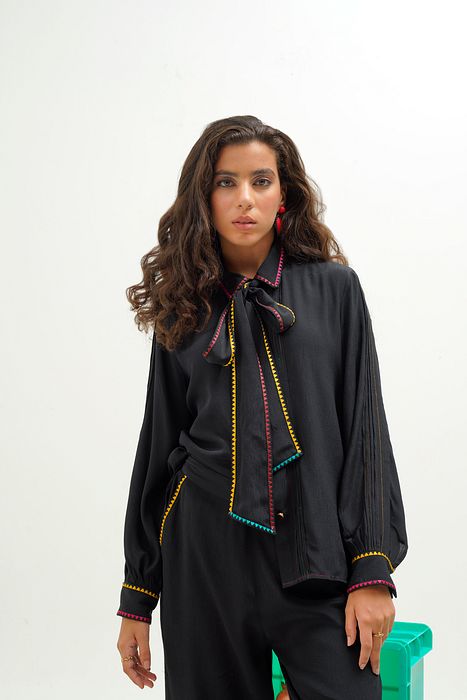 A model showcasing Elodie Shirt by Stitch Stories from Stitch Stories's collection