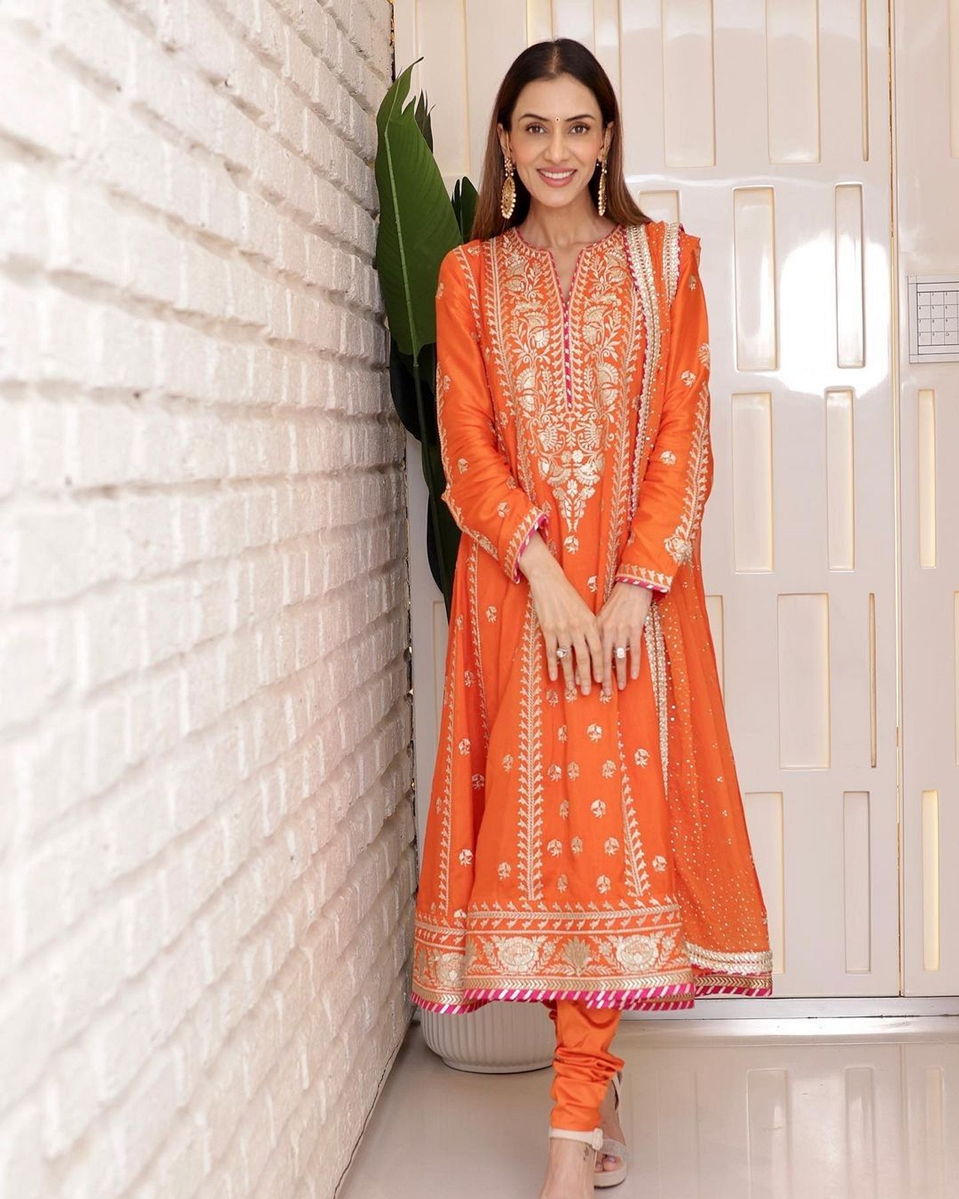 A model showcasing Smriti Khanna In Orange Golconda Aarohi Anarkali Set Feature image by Gopi Vaid from Gopi Vaid's collection