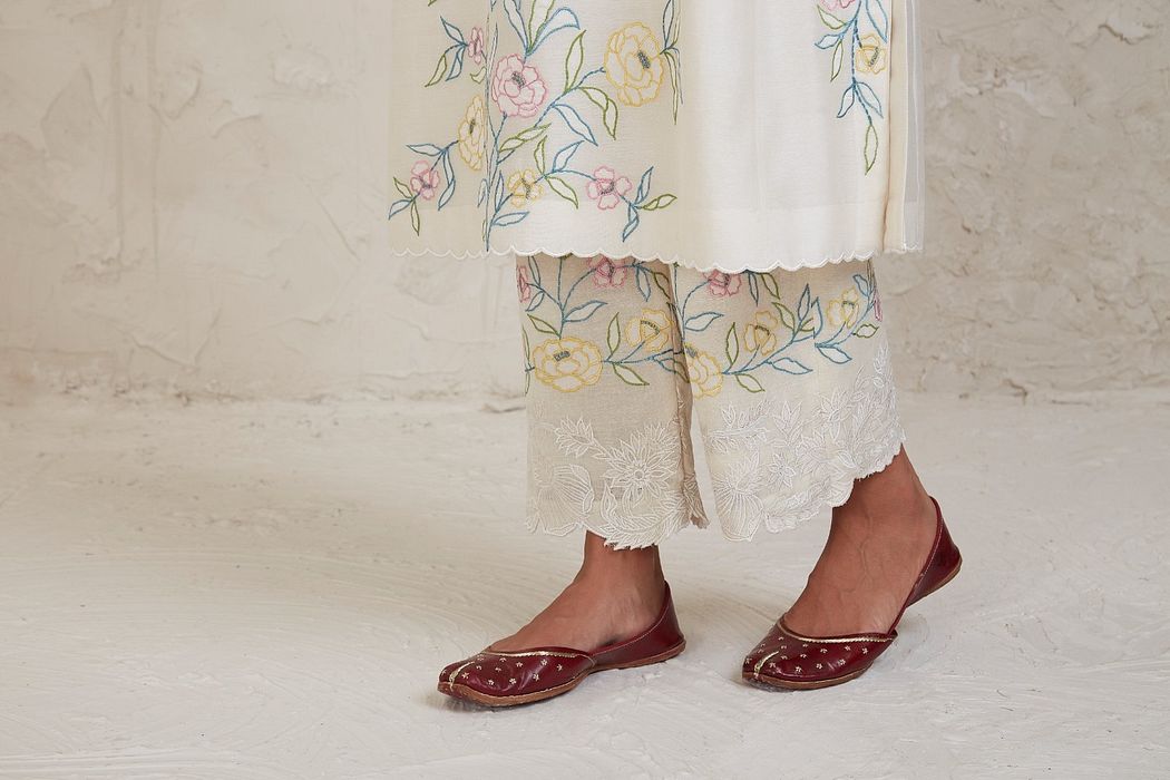A model showcasing Aima Off White A Line Kurta Set by Sue Mue from Sue Mue's collection