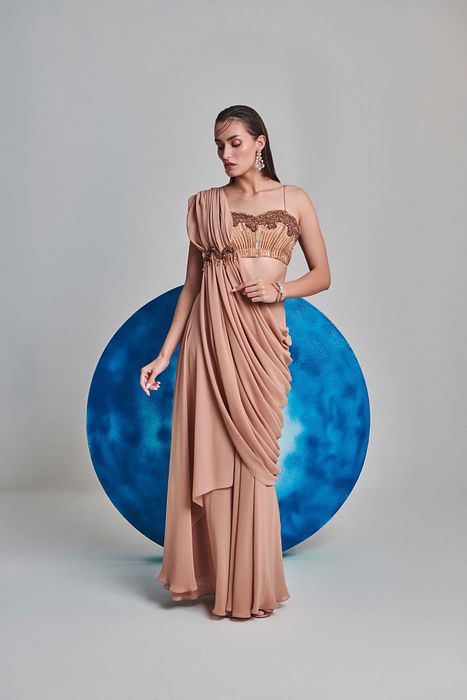 A model showcasing Beige Flared Pre Stitched Drape Saree by One Knot One from One Knot One's collection