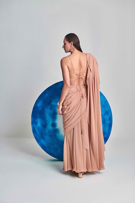 A model showcasing Beige Flared Pre Stitched Drape Saree by One Knot One from One Knot One's collection