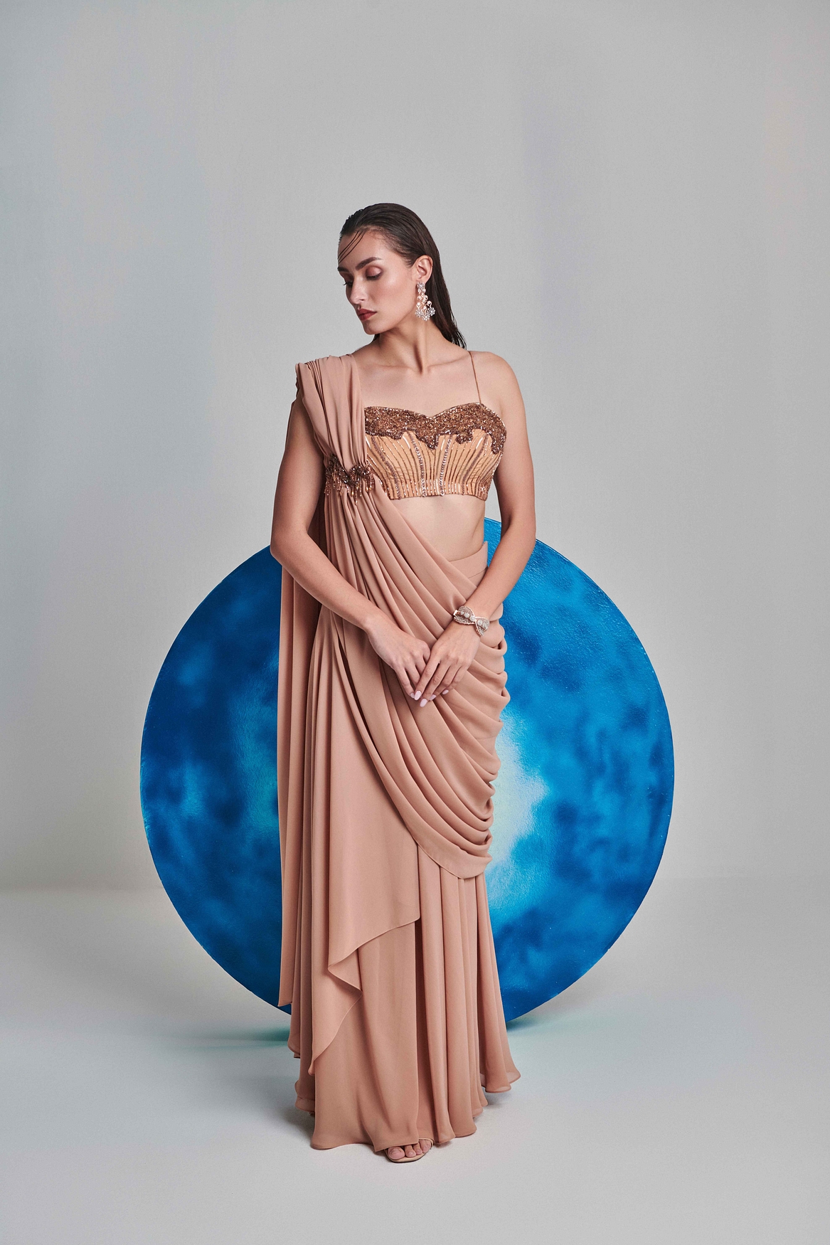 A model showcasing Beige Flared Pre Stitched Drape Saree Feature image by One Knot One from One Knot One's collection