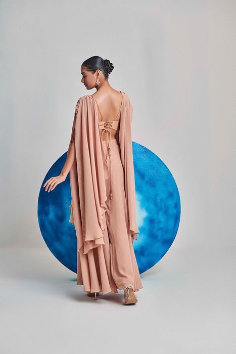 A model showcasing Beige Cape And Sharara Set by One Knot One from One Knot One's collection