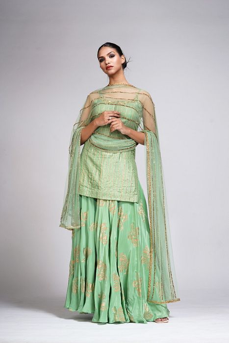 A model showcasing Silk Sharara Suit In Sage Green by Shruti S Label from Shruti S Label's collection