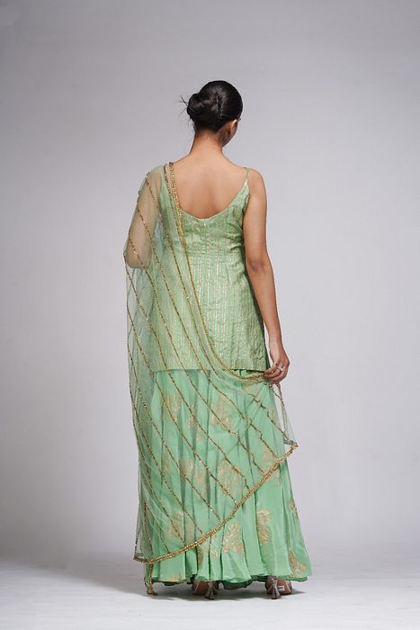 A model showcasing Silk Sharara Suit In Sage Green by Shruti S Label from Shruti S Label's collection