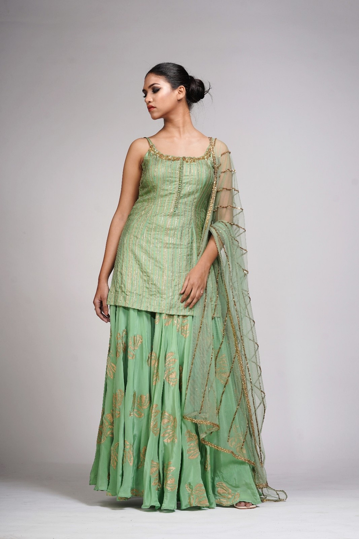 A model showcasing Silk Sharara Suit In Sage Green Feature image by Shruti S Label from Shruti S Label's collection