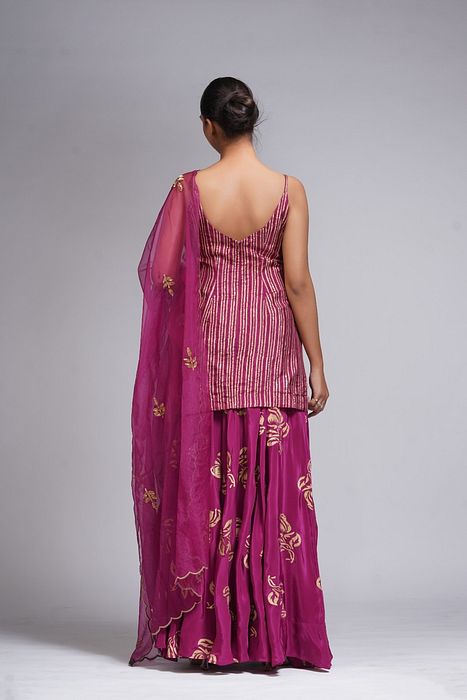 A model showcasing Hand Work Block Print Wine Sharara Suit by Shruti S Label from Shruti S Label's collection
