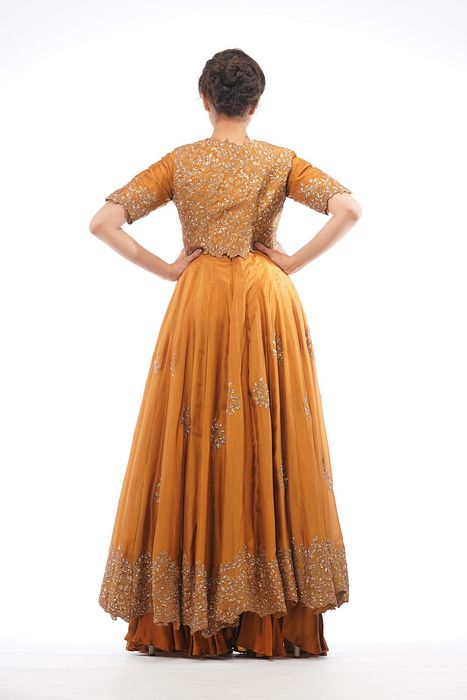 A model showcasing Classic Jacket Anarkali In Ochre by Shruti S Label from Shruti S Label's collection