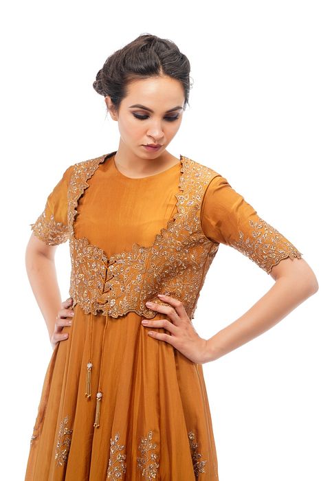 A model showcasing Classic Jacket Anarkali In Ochre by Shruti S Label from Shruti S Label's collection