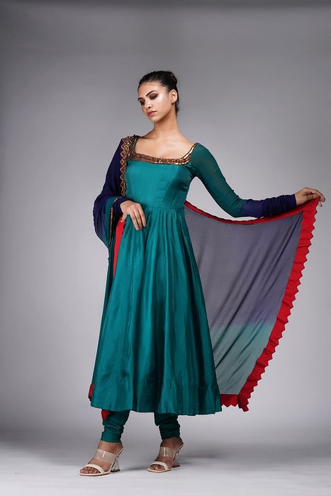 A model showcasing Teal Anarkali With Gold Embroidery by Shruti S Label from Shruti S Label's collection