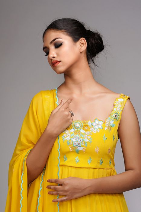 A model showcasing Thread Mirror Work Anarkali In Yellow by Shruti S Label from Shruti S Label's collection
