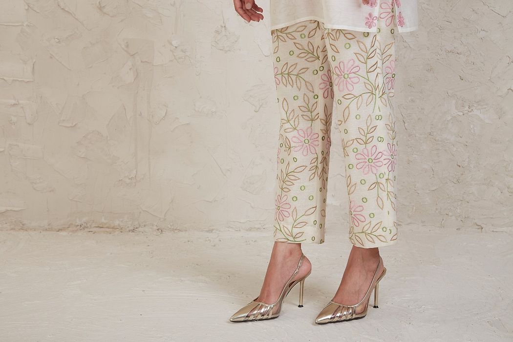 A model showcasing Amal Off White Short Kurta Set by Sue Mue from Sue Mue's collection