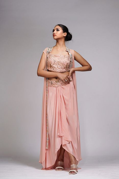A model showcasing Peach Draped Dhoti Skirt And Cape by Shruti S Label from Shruti S Label's collection
