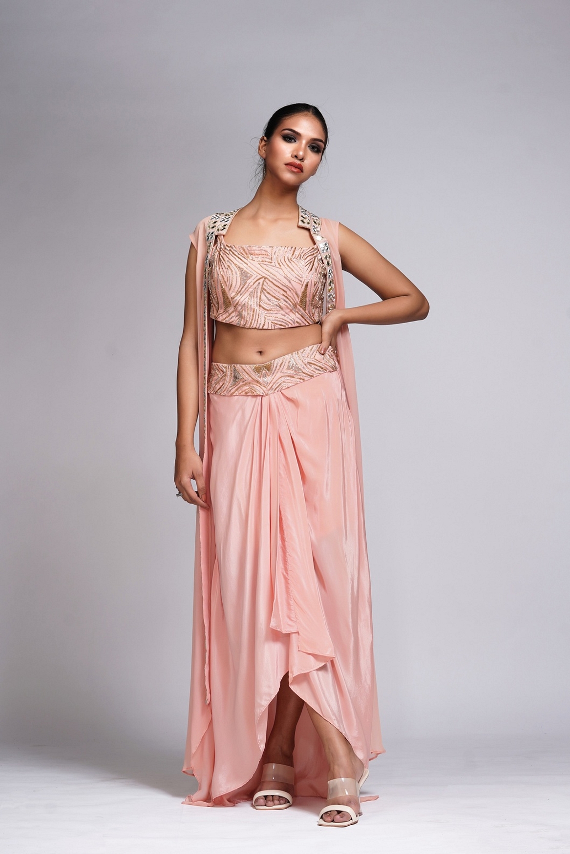 A model showcasing Peach Draped Dhoti Skirt And Cape Feature image by Shruti S Label from Shruti S Label's collection