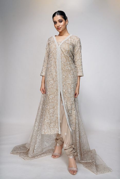 A model showcasing Pearl Work With Hand Painted Nude Suit by Shruti S Label from Shruti S Label's collection