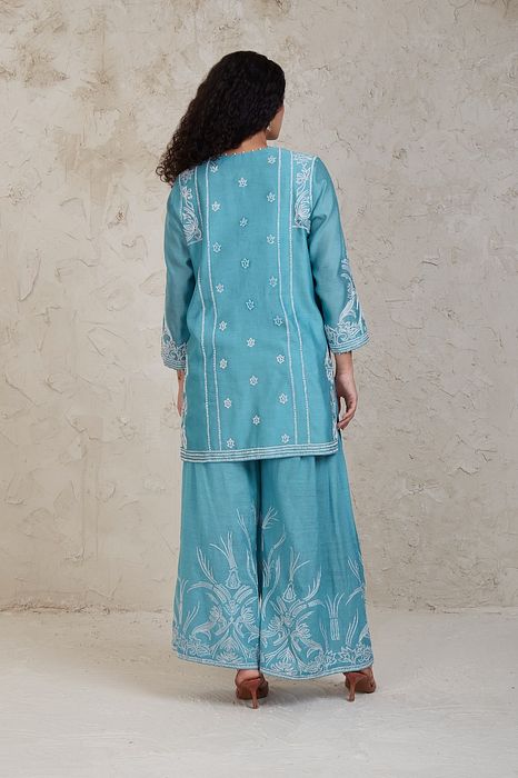 A model showcasing Fairoz Blue Short Kurta Set by Sue Mue from Sue Mue's collection