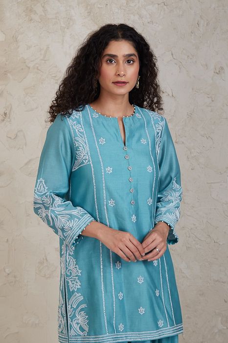 A model showcasing Fairoz Blue Short Kurta Set by Sue Mue from Sue Mue's collection