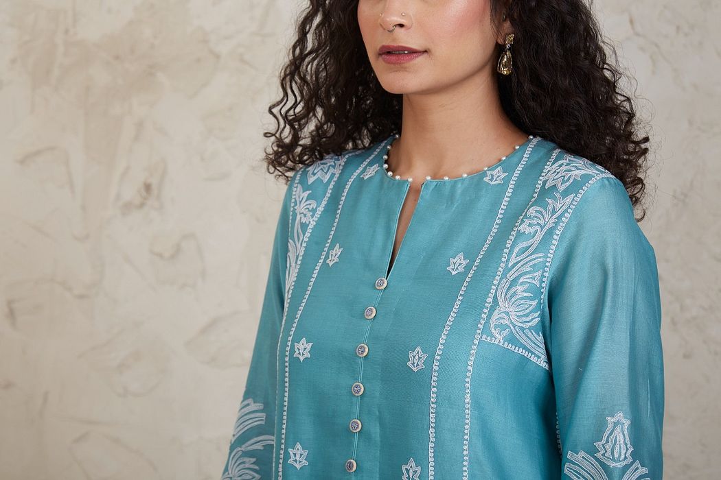 A model showcasing Fairoz Blue Short Kurta Set by Sue Mue from Sue Mue's collection