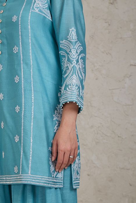 A model showcasing Fairoz Blue Short Kurta Set by Sue Mue from Sue Mue's collection