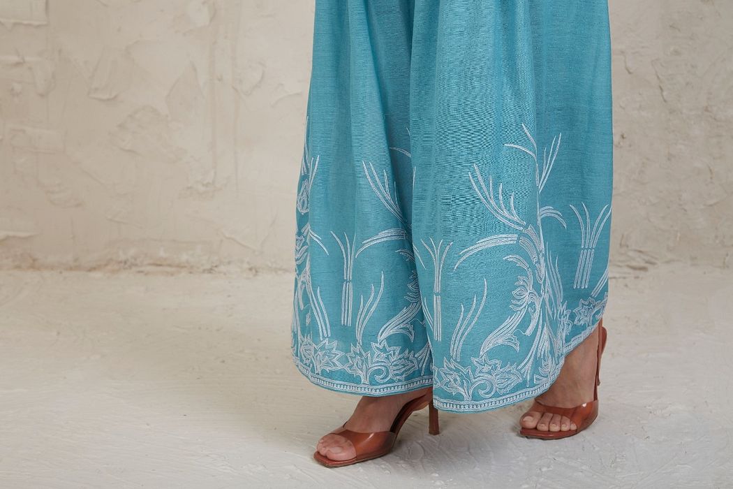 A model showcasing Fairoz Blue Short Kurta Set by Sue Mue from Sue Mue's collection