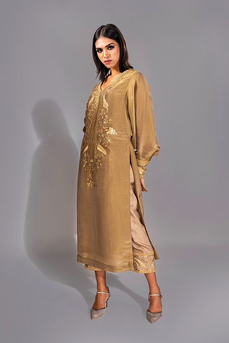 A model showcasing Golden Kaftan Suit by Shruti S Label from Shruti S Label's collection