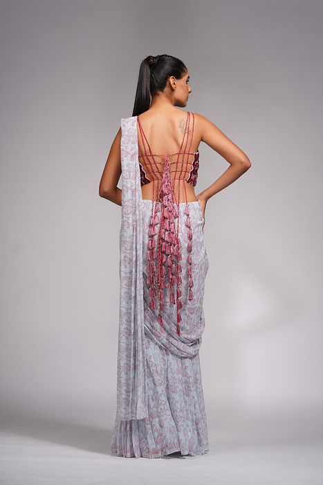A model showcasing Red Embroidery Hand Painted Bell Bottom Saree by Shruti S Label from Shruti S Label's collection
