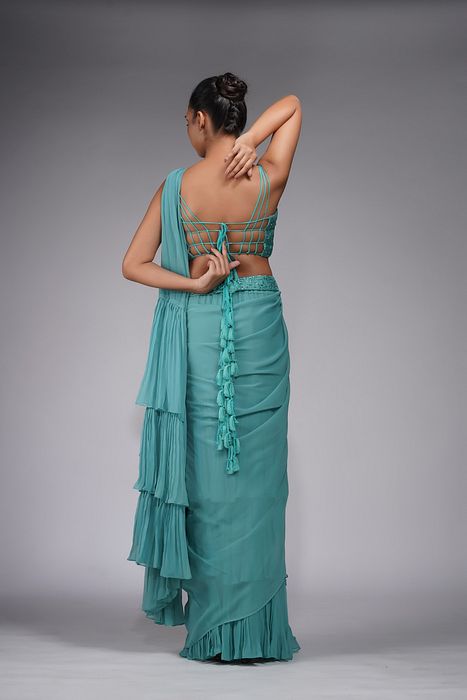 A model showcasing Embroidered Ruffle Saree Green by Shruti S Label from Shruti S Label's collection