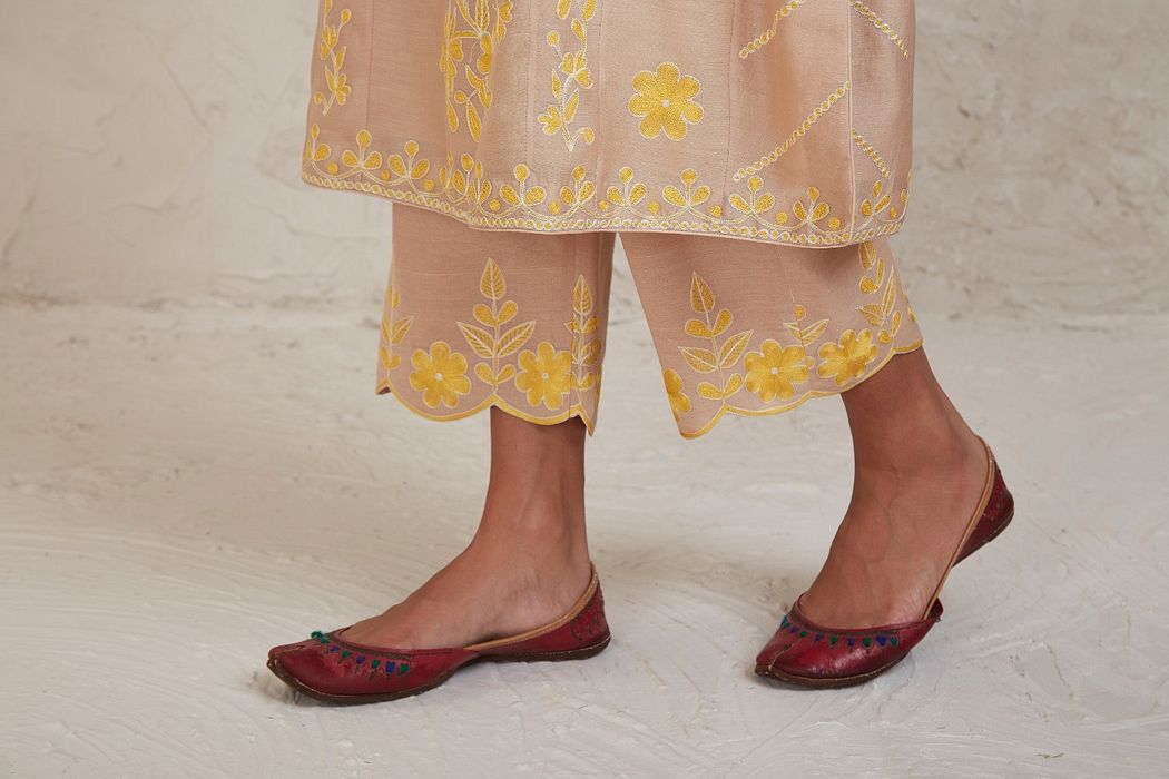 A model showcasing Hanan Beige Kurta Set by Sue Mue from Sue Mue's collection
