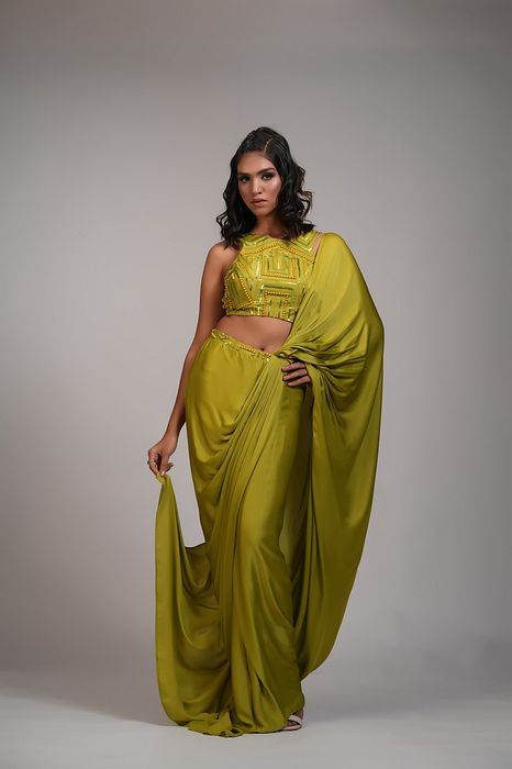A model showcasing Mustard Green Drape Satin Saree by Shruti S Label from Shruti S Label's collection
