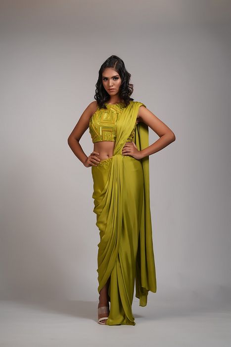 A model showcasing Mustard Green Drape Satin Saree by Shruti S Label from Shruti S Label's collection