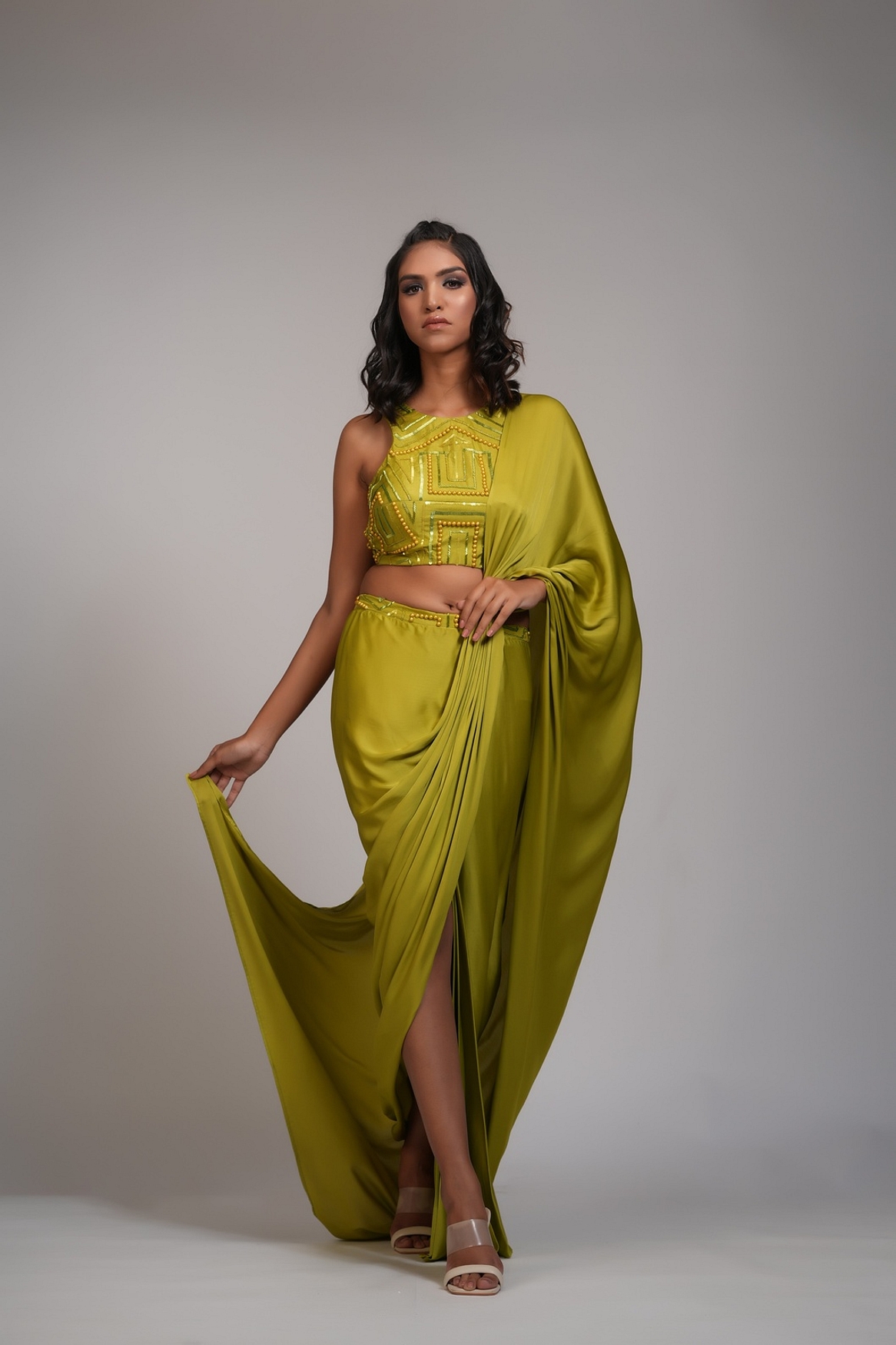 A model showcasing Mustard Green Drape Satin Saree Feature image by Shruti S Label from Shruti S Label's collection