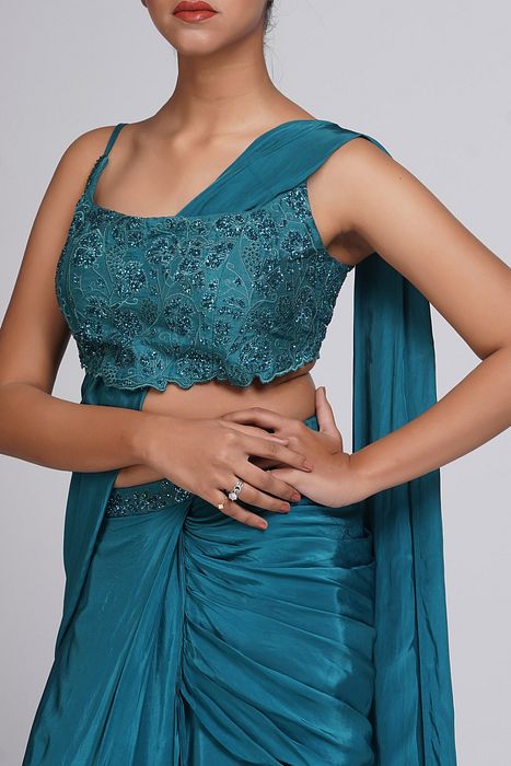 A model showcasing Grapevine Teal Green Pre Stitched Saree by Shruti S Label from Shruti S Label's collection